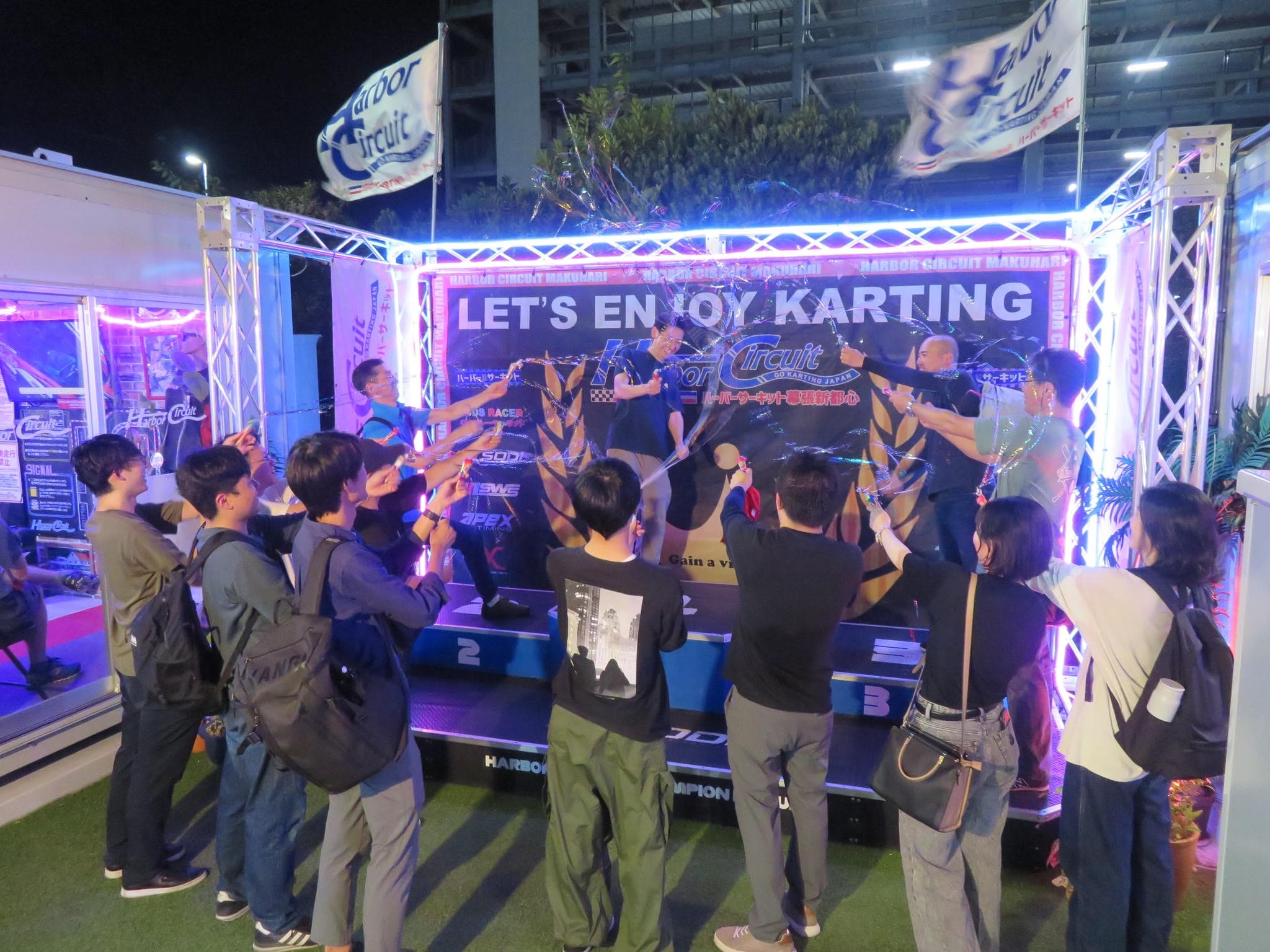 Makuhari group race participants celebrating the podium with party poppers
